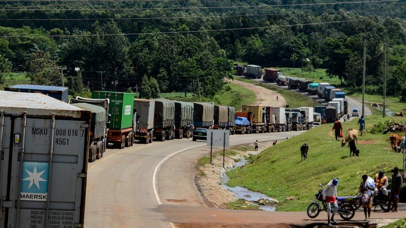 Trucks wait in a line on the road to enter Uganda in Malaba